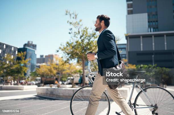 Shot Of A Young Businessman Traveling Through The City With His Bicycle Stock Photo - Download Image Now