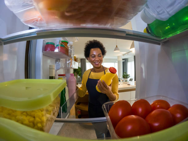 istock Woman looking at food in refrigerator 1368051381