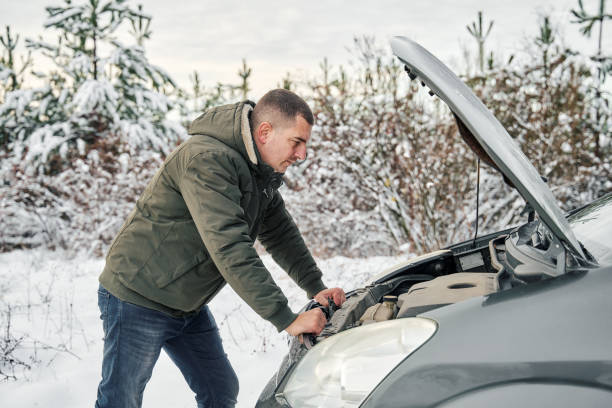 istock Man checking his broken car’s engine on the road 1368052589