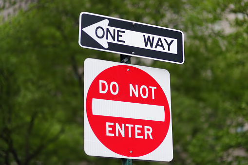 'Do not enter' and 'One way' road signs in New York, Manhattan, USA. City life concept.