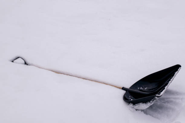 istock snow shovel lies on the white snow 1368059920