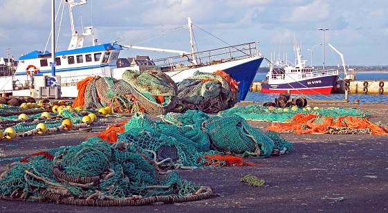 Commercial fishing trawlers on the quayside, Lorient waterfront, Morbihan, France. Lorient is one of the large commercial ports of Brittany, northwest France, in the Morbihan department,  named after the Morbihan, a shallow enclosed sea that is the principal coastline feature that features many hamlets, villages and idyllic islands