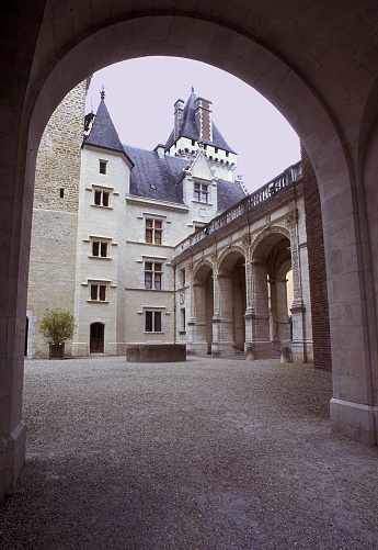 Arched arcade and chateau, Pau, Pyrénées-Atlantiques,, Southwest France. Pau is a city at the base of the Pyrenees mountains that initially grew around its castle but became popular with foreign tourists escaping their winter