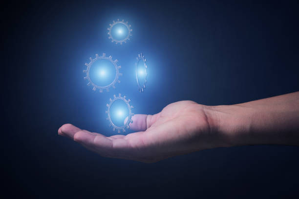 istock Hand and levitating glowing blue mechanisms on gray background.Concept progress, development, innovation and technology. 1368061567