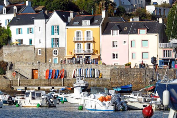 Watercraft on the waterfront, Sauzon harbour, La Belle Ile, Morbihan, France. Sauzon is one of the main ports on the island and a tourist attraction with its beautiful architecture and tidal basin marina that attracts recreational sailors and fishing boats alike