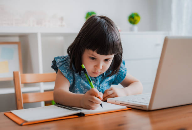 istock Distance learning online education. A schoolboy boy studies at home and does school homework. A home distance learning 1368064194