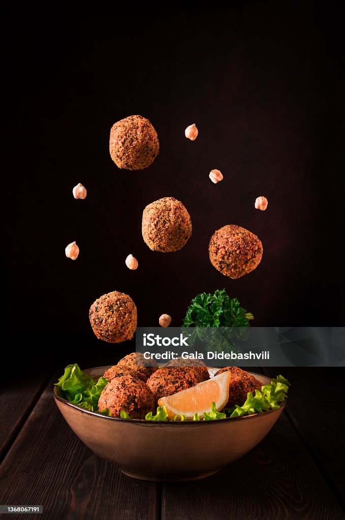 Chickpea falafel balls, on a wooden table, close-up, levitation, vertical,vegetarian food, Chickpea falafel balls, on a wooden table, close-up, vegetarian food,levitation, vertical, Falafel Stock Photo