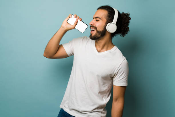 istock Latin man singing his favorite song 1368067460
