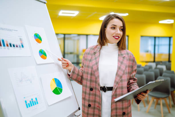Young woman leader, presenter, make a business presentation at a conference in the office. stock photo