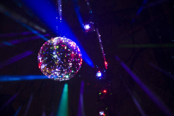 istock Mirrored Disco Ball and bright beams at the night party 1368071961