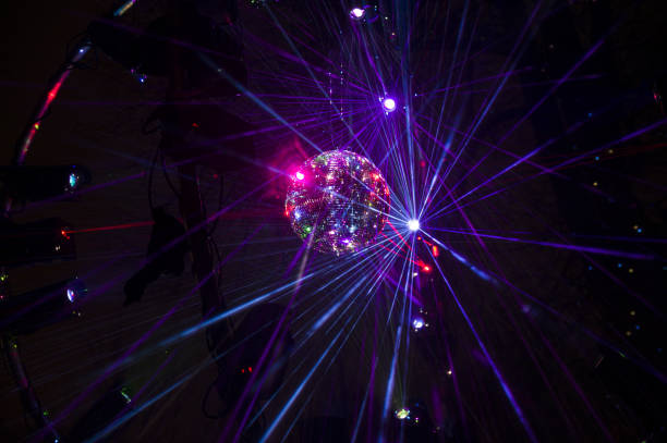 istock Mirrored Disco Ball and bright beams at the night party 1368072017