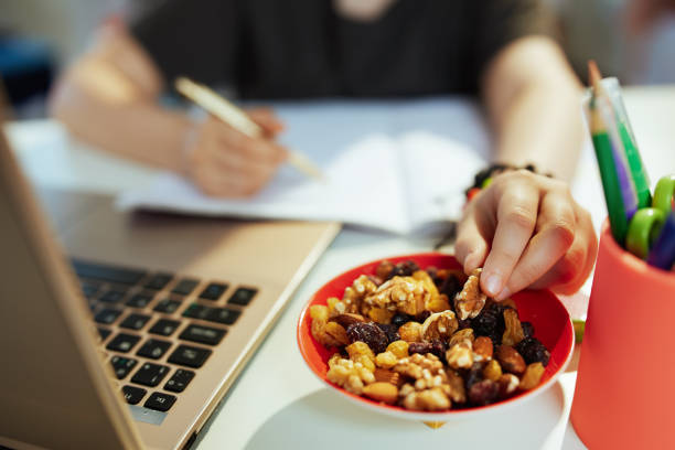 istock Modern pupil having online education and eating healthy snack 1368072075