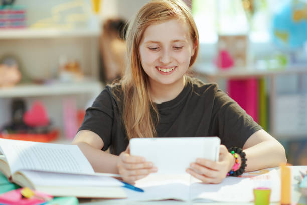 istock smiling child having online education at home in sunny day 1368072085
