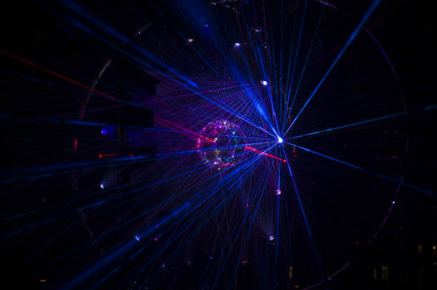 istock Mirrored Disco Ball and bright beams at the night party 1368072297