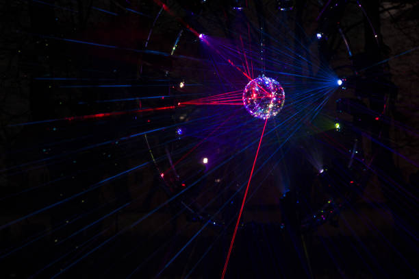 istock Mirrored Disco Ball and bright beams at the night party 1368072306
