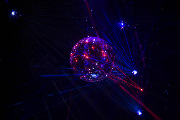 istock Mirrored Disco Ball and bright beams at the night party 1368072375