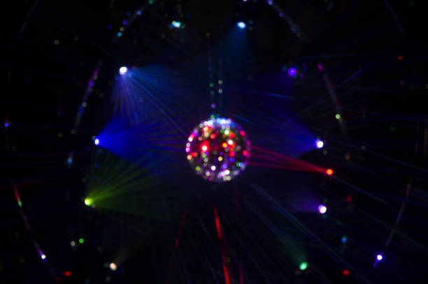 istock Mirrored Disco Ball and bright beams at the night party 1368073155