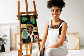 Carefree female painter smiling in her studio