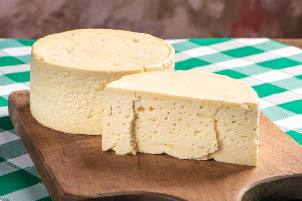 istock Semi-cured cheese from Brazil arranged on a rustic board on a green and white checkered tablecloth, selective focus. 1368079477