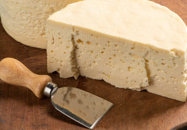 istock Semi-cured cheese from Brazil arranged on a rustic board on a green and white checkered tablecloth, selective focus. 1368079572