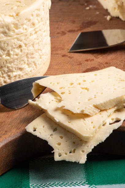 istock Semi-cured cheese from Brazil arranged on a rustic board on a green and white checkered tablecloth, selective focus. 1368079725