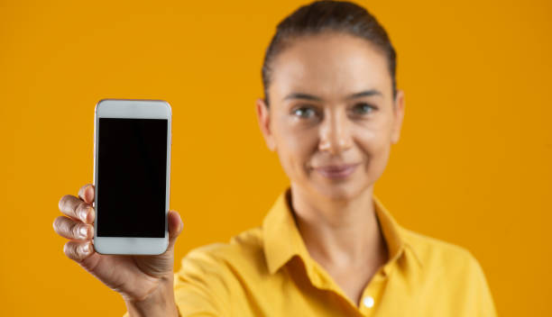 istock Woman Showing Smart Phone 1368080595
