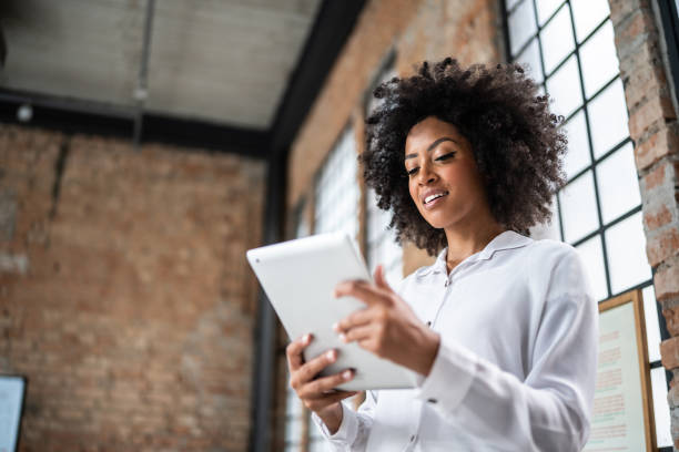 istock Young business woman using digital tablet in an office 1368082517