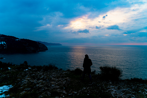 A fantastic shot of a rocky beach and a calm sea on beautiful sky background