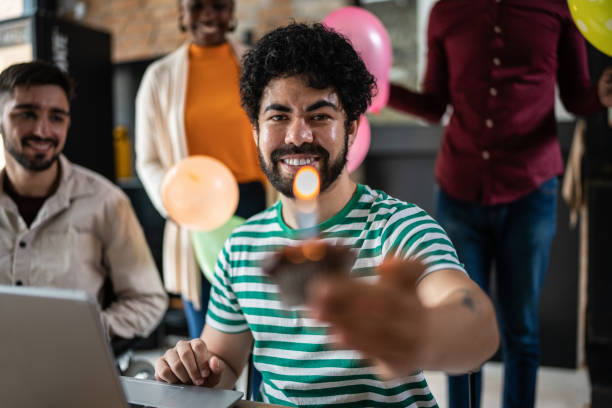 istock Man showing cupcake with birthday candle 1368084453