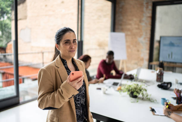 istock Visually impaired businesswoman using smartphone in the office 1368084495
