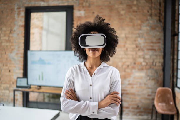 istock Young woman using virtual reality glasses in the office 1368084878