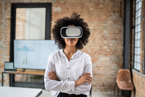 istock Young woman using virtual reality glasses in the office 1368084884