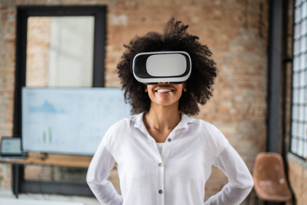 istock Young woman using virtual reality glasses in the office 1368084885