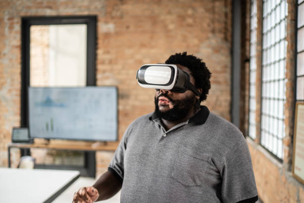 istock Mid adult man using a virtual reality glasses in the office 1368084928