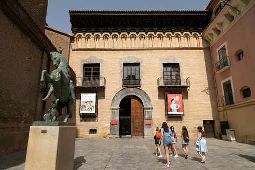 Zaragoza, Spain - 12 Aug. 2021: A group of young girls walk towards the entrance of the Pablo Gargallo Museum in Zaragoza, in San Felipe square