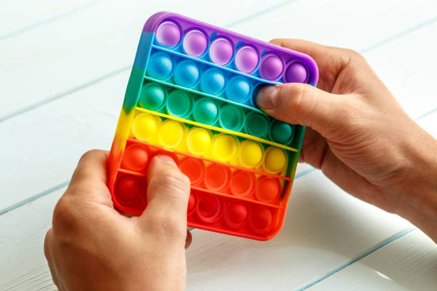 istock a man's hand presses on a colored rainbow silicone anti-stress toy pop it.Relaxation multicolored sensory pop it toy.New sensory antistress toy for children and adult. 1368088717