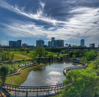 William E. Clark Wetlands at the Clinton Presidential Park on a spring day with the Little Rock Skyline in the background.  The park   include 13 acres of restored wetlands and a 1,600-foot boardwalk for visitors to discover the wildlife and river life that inhabit the area.