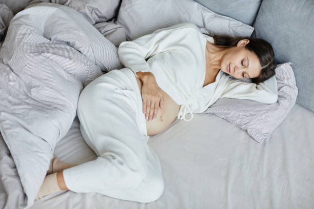 istock Pregnant woman resting in her bed 1368091053