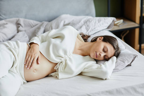 istock Pregnant woman sleeping in bed at home 1368091061