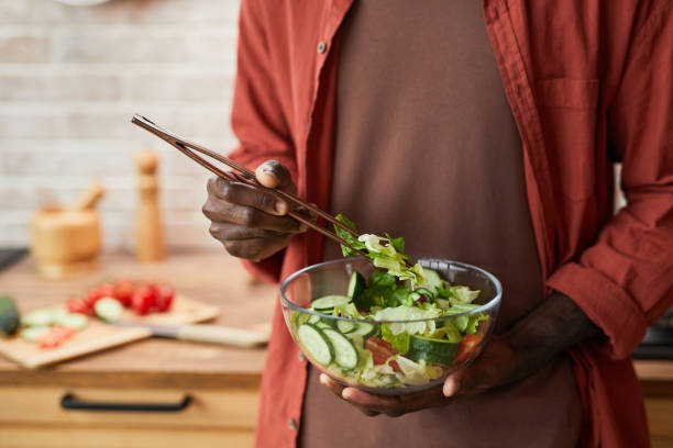 istock Man Mixing Salad Close Up 1368091491