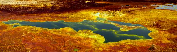 Panorama of surreal colors and Mars like landscape created by sulphur springs forming bright colors in the hottest place on earth, the Danakil Depression in Ethiopia. stock photo