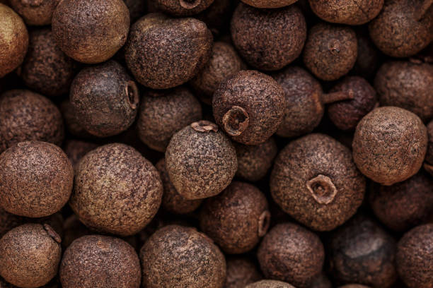 istock Peppercorn background. Dry black pepper seeds. Top view. Flat design. Macro spice background 1368094698
