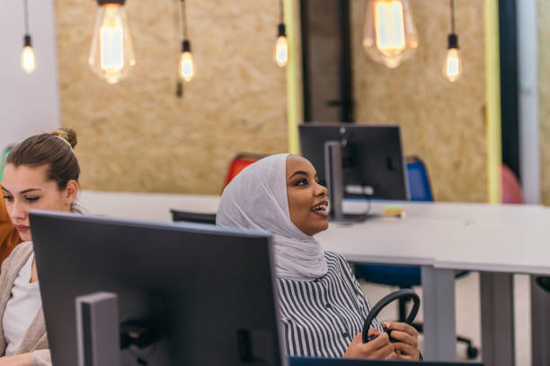 istock African girl with hijab and headset working  as customer support in a modern office. 1368095180