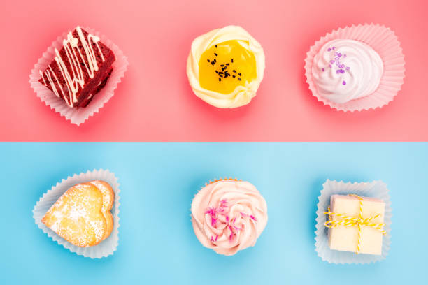 istock Colorful cupcakes on a blue and pink background 1368095219