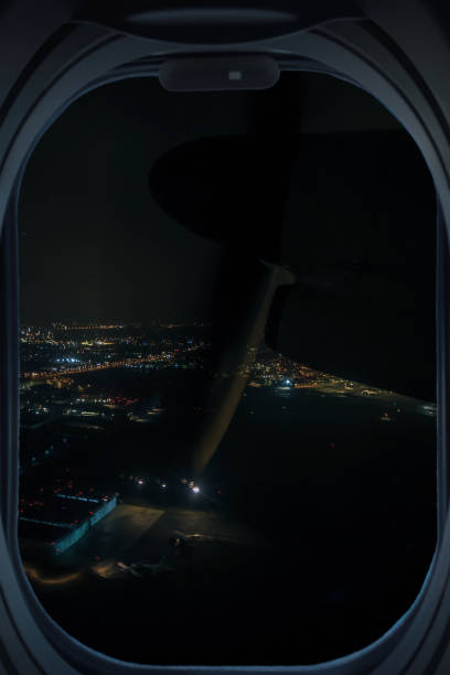 istock Passenger plane window and a city at night 1368097188