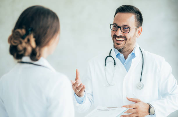 istock Two healthcare workers talking at hospital 1368099667