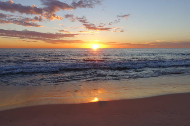 istock Sunset Over a Calm Sea and Sandy Beach 1368099689
