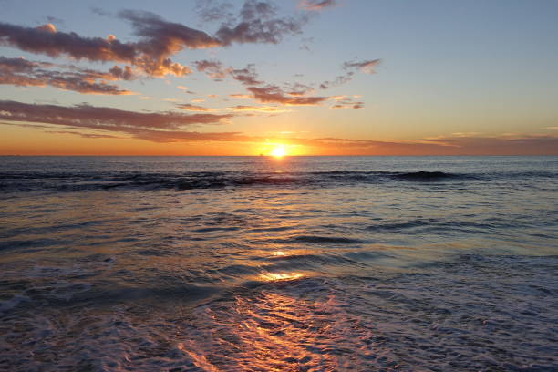 istock Sunset Over a Calm Sea and Sandy Beach 1368099697