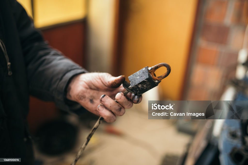 Old man holding an old part of a car closeup. Old man holding an old part of a car closeup. in Malo Laole, Braničevo District, Serbia 80-89 Years Stock Photo