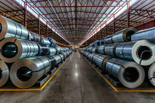 Rolls of galvanized steel sheet inside the factory or warehouse.